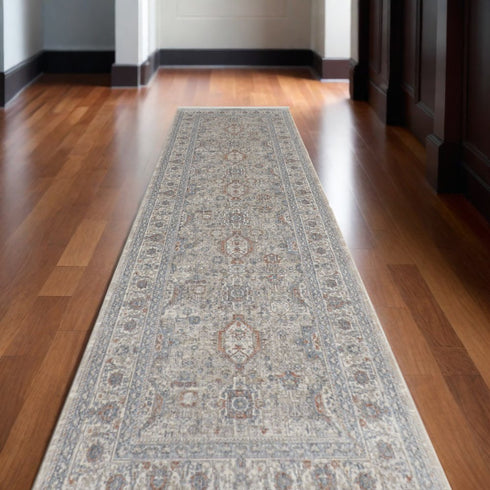 7' X 10' Silver Taupe and Blue Oriental Power Loom Worn Faded Area Rug With Fringe